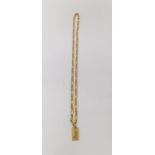 An 18 carat yellow gold Figaro chain with engraved zodiac rectangular pendant. Fastens with a secure