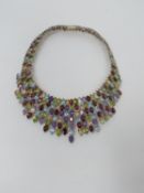 A bespoke silver and multi gemstone collar necklace, set with fifty two oval mixed cut Peridots,