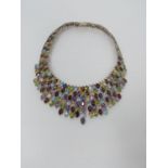 A bespoke silver and multi gemstone collar necklace, set with fifty two oval mixed cut Peridots,