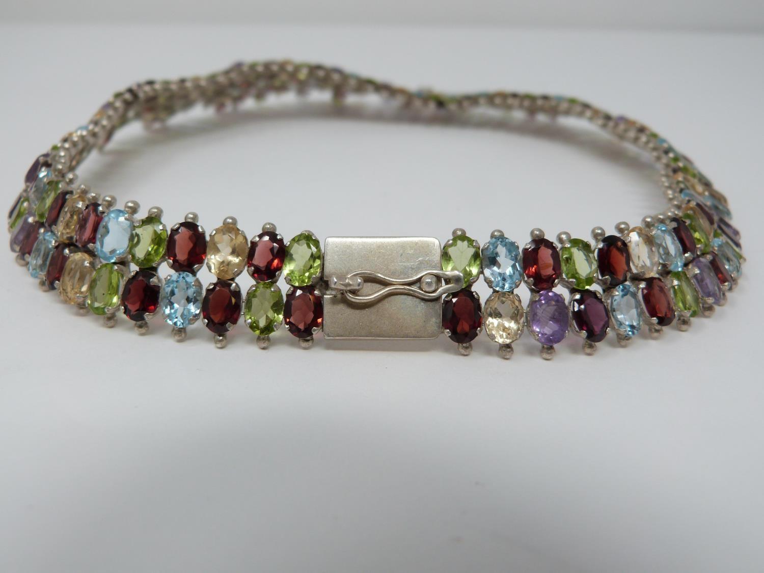 A bespoke silver and multi gemstone collar necklace, set with fifty two oval mixed cut Peridots, - Image 4 of 9