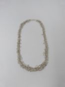 A bespoke Moonstone and silver graduated garland necklace. The oval moonstones set in individual