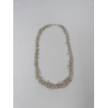 A bespoke Moonstone and silver graduated garland necklace. The oval moonstones set in individual