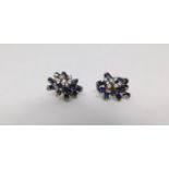 A pair of vintage white metal and yellow metal sapphire and diamond abstract clip earrings. Each