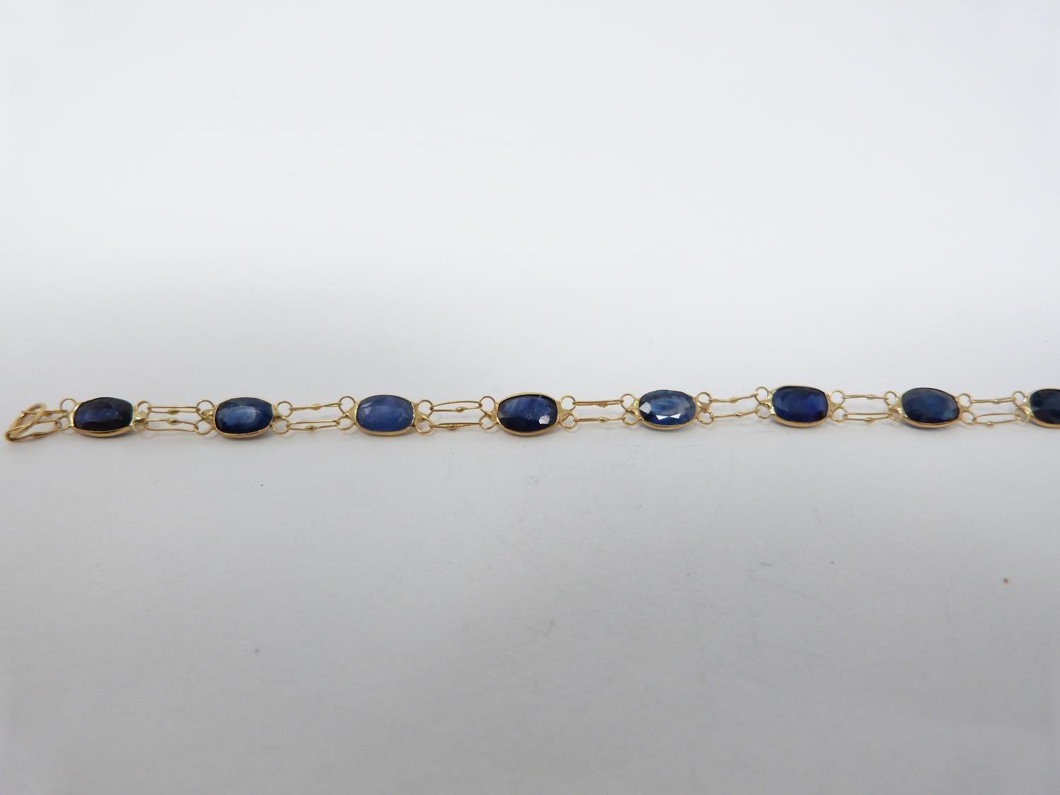 A bespoke heated ceylon sapphire and yellow metal (tested 14 carat yellow gold) chain bracelet, - Image 4 of 8