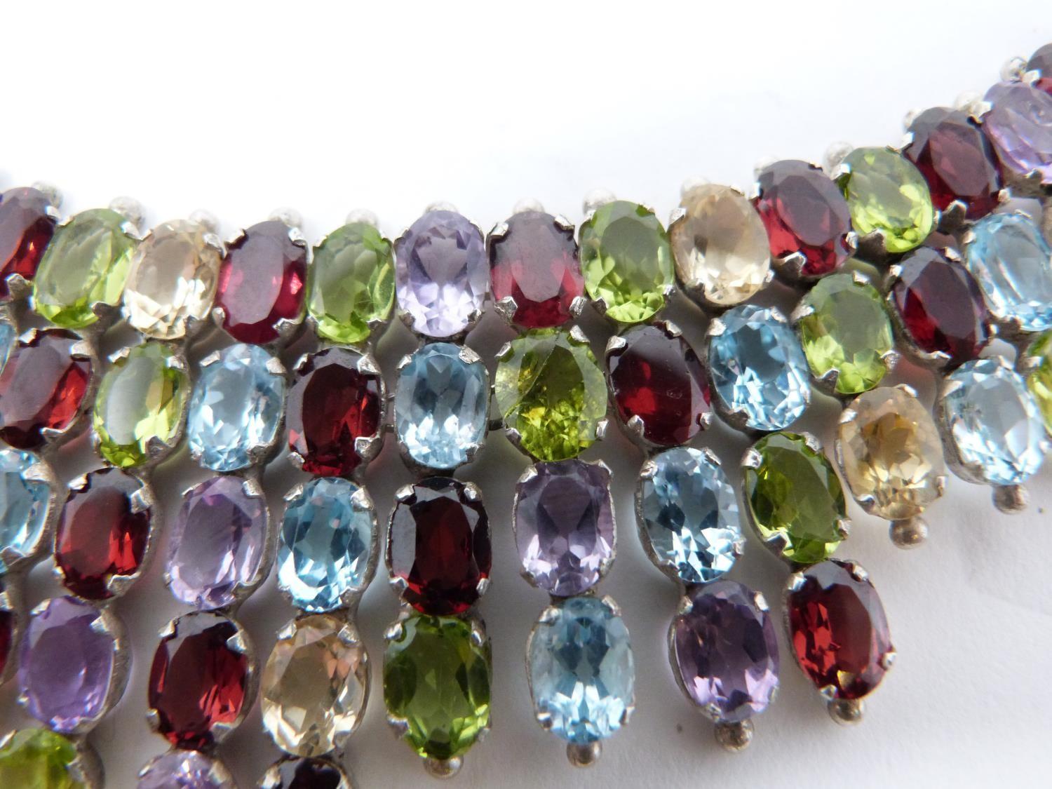 A bespoke silver and multi gemstone collar necklace, set with fifty two oval mixed cut Peridots, - Image 8 of 9