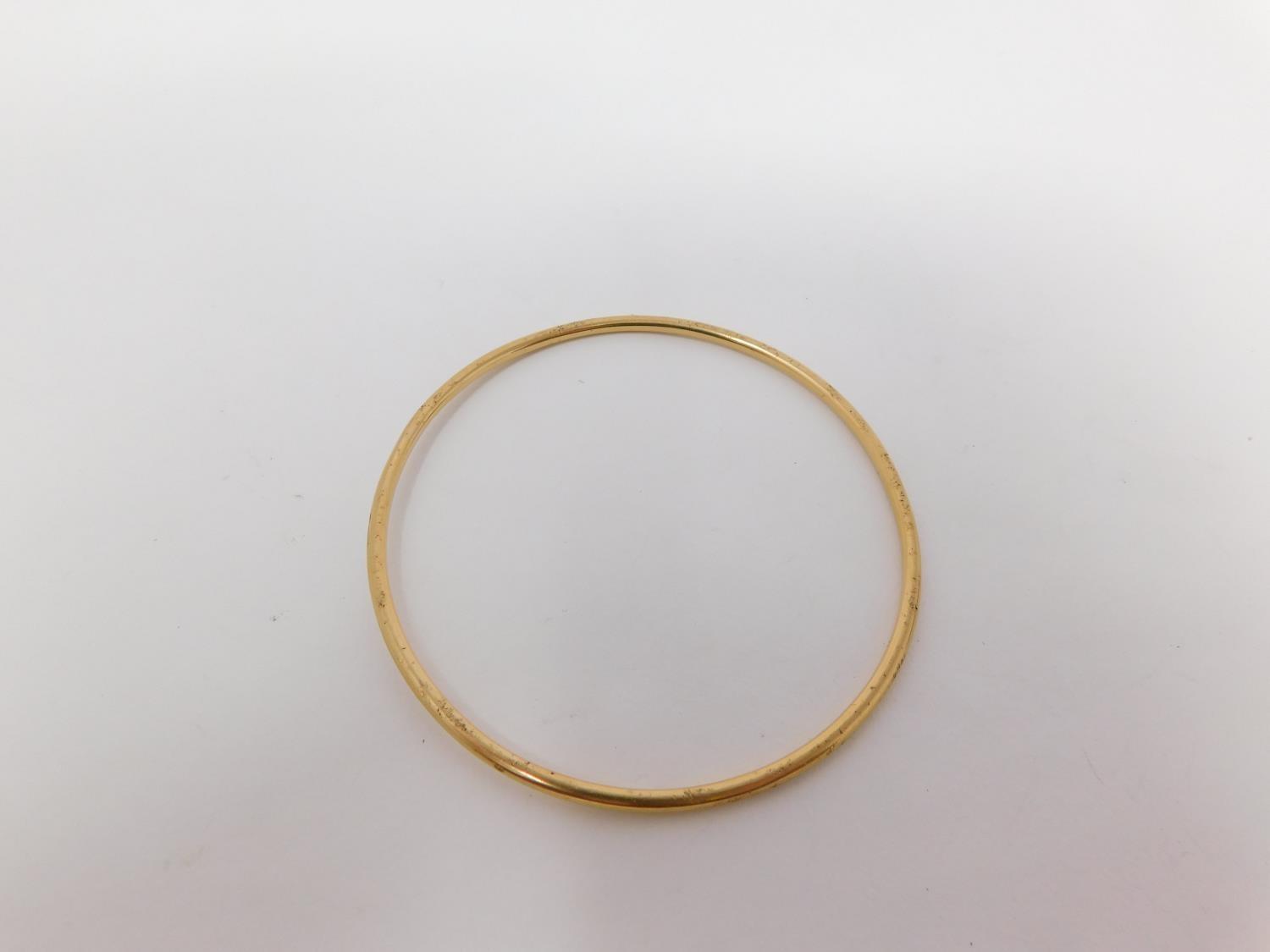 A yellow metal bangle. Foreign hallmark. Weight 11.2 g, 6.3 diameter.