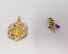 An 18 carat white and yellow gold pierced Santa Maria pendant and 9 carat yellow gold charm