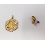 An 18 carat white and yellow gold pierced Santa Maria pendant and 9 carat yellow gold charm