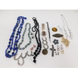 A collection of vintage jewelery. Including a micro mosaic cross with flowers and a dove of peace, a