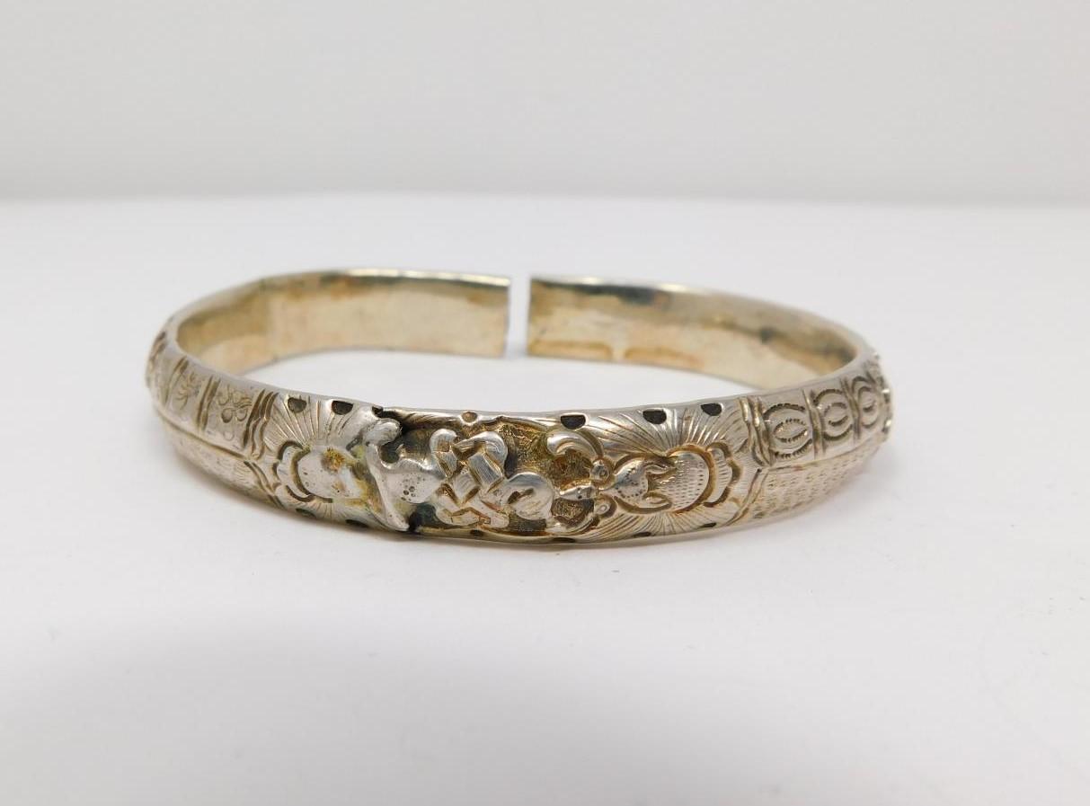 An antique Chinese engraved white metal bangle and toggle buttons. The bangle is engraved with a - Image 3 of 14