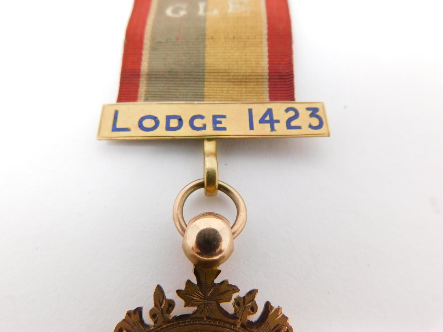 A 9 ct rose gold and enamel engraved Masonic lodge 1423 medal on an embroidered silk ribbon. - Image 3 of 8