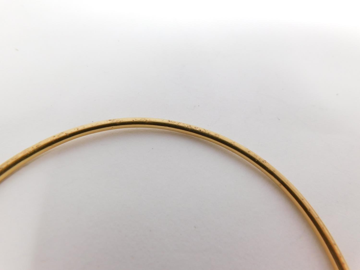 A yellow metal bangle. Foreign hallmark. Weight 11.2 g, 6.3 diameter. - Image 4 of 8