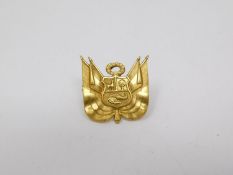 A yellow metal plated Peruvian military insignia screw pin badge. Intricately detailed. Width 2 cm.