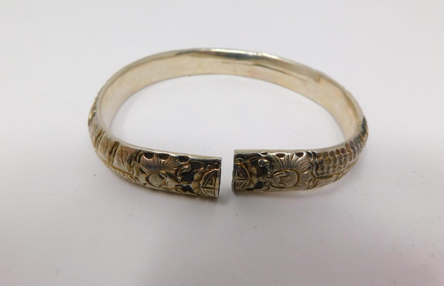 An antique Chinese engraved white metal bangle and toggle buttons. The bangle is engraved with a - Image 9 of 14