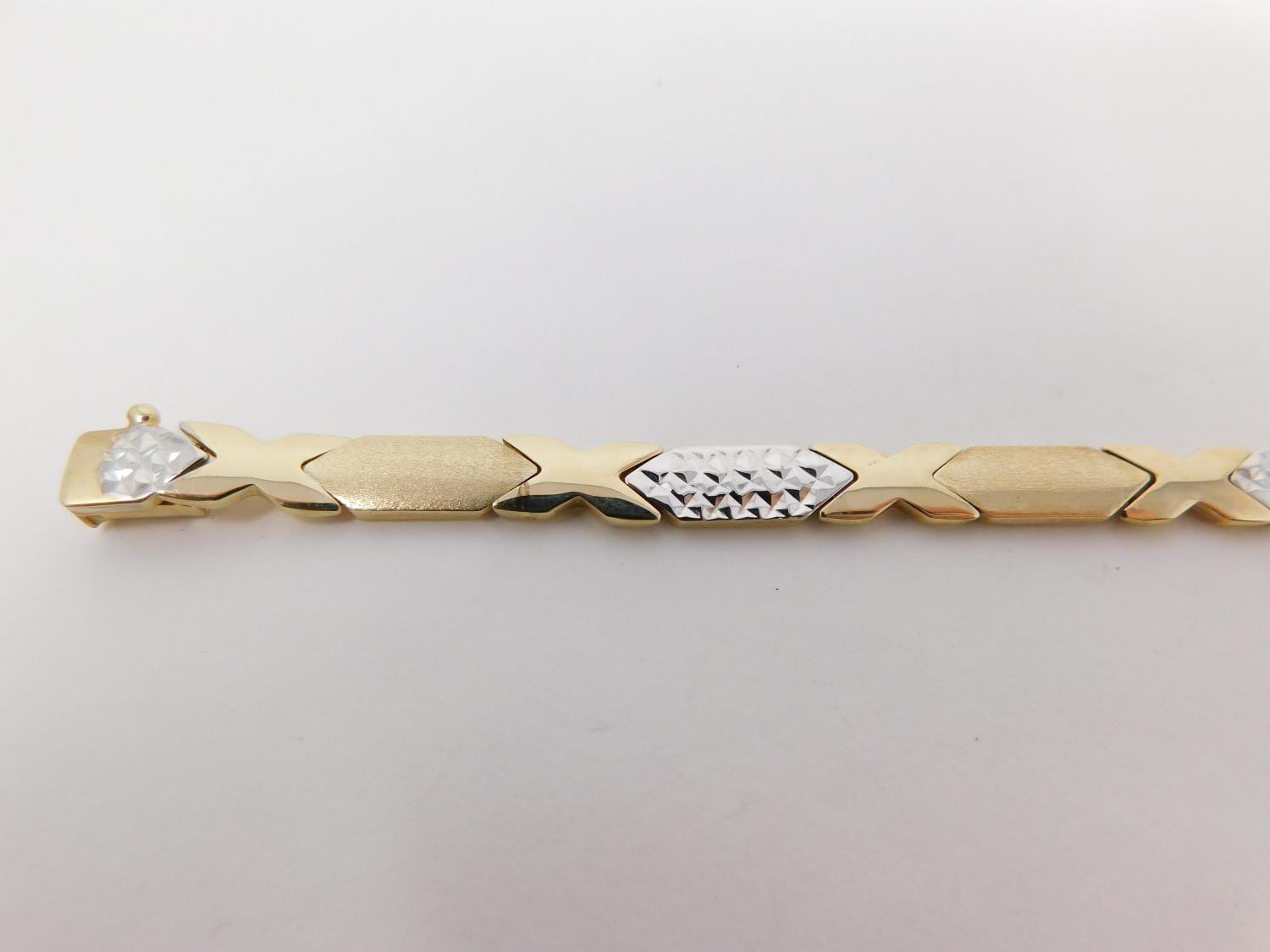 A 14 carat bi-colour gold articulated bracelet, with cross-hatched texture and X-shape design. - Image 2 of 10