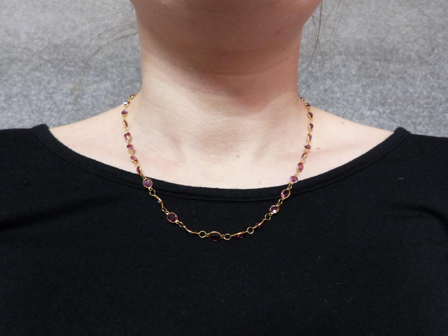 A bespoke yellow metal (tested 14 carat yellow gold) and ruby chain necklace. Set with fifty one - Image 2 of 6