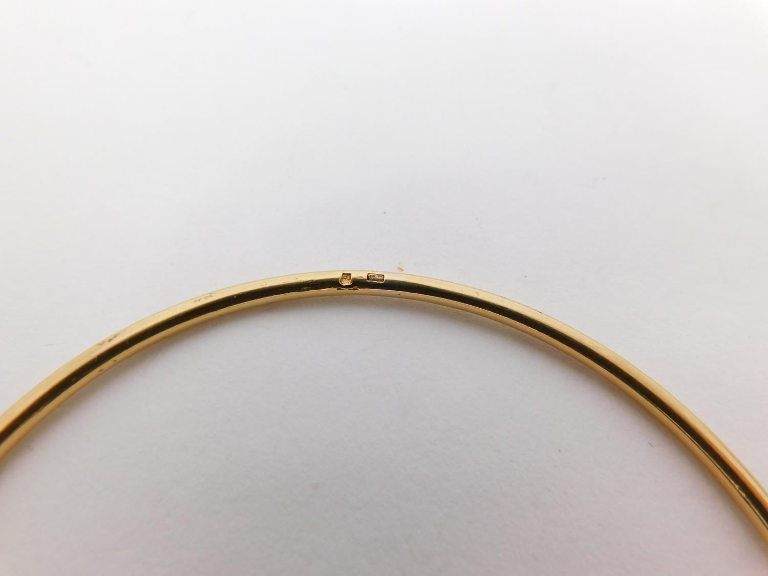 A yellow metal bangle. Foreign hallmark. Weight 11.2 g, 6.3 diameter. - Image 6 of 8