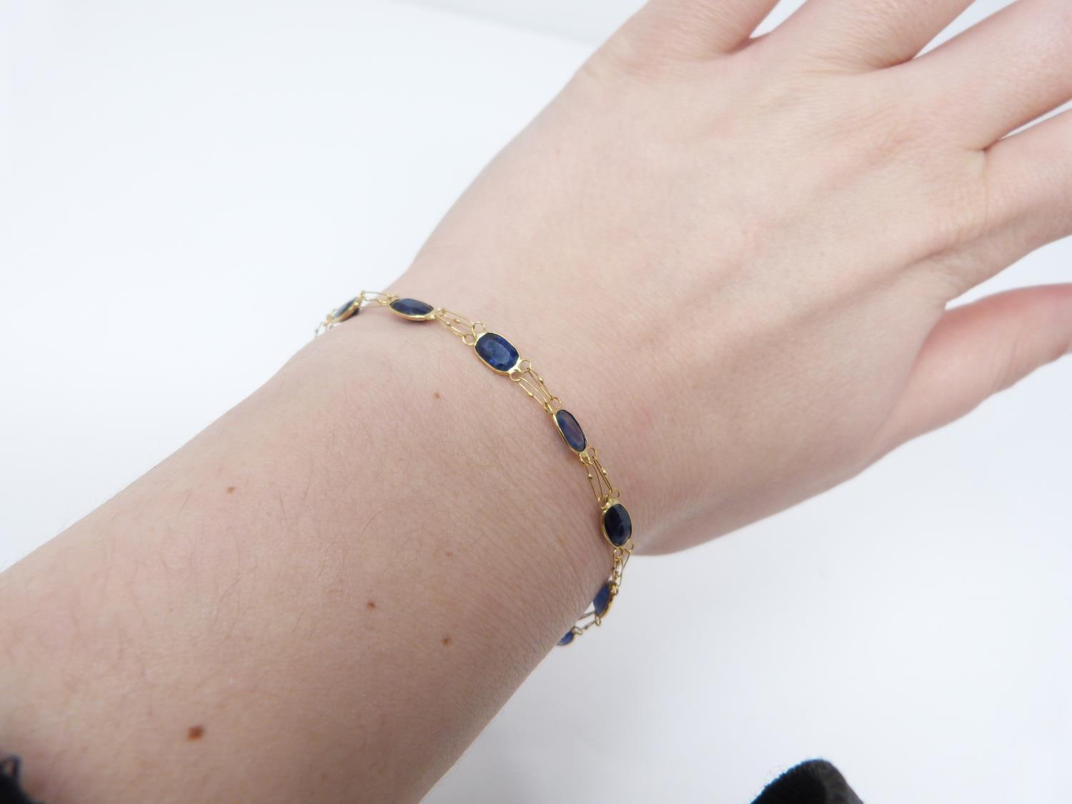 A bespoke heated ceylon sapphire and yellow metal (tested 14 carat yellow gold) chain bracelet, - Image 8 of 8