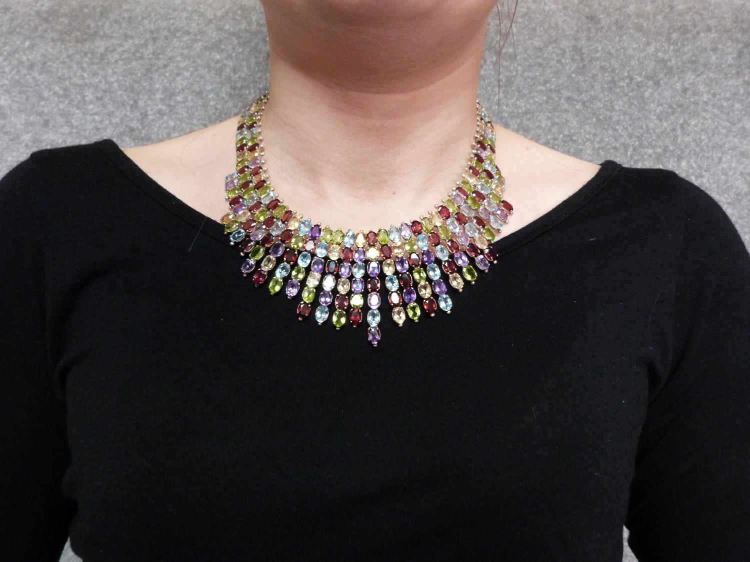 A bespoke silver and multi gemstone collar necklace, set with fifty two oval mixed cut Peridots, - Image 9 of 9