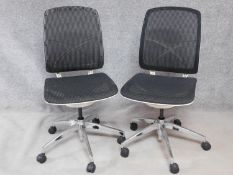 A pair of contemporary swivelling adjustable office desk chairs with mesh backs and seats. H.100