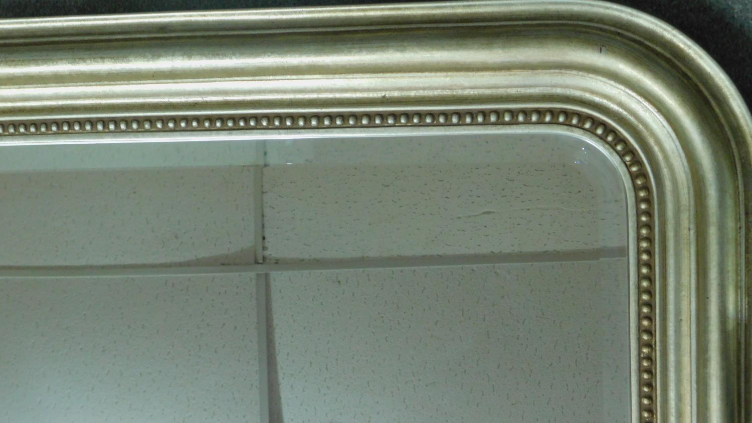 A 19th century style overmantel mirror in silvered moulded arched frame inset with bevelled plate. - Image 2 of 2