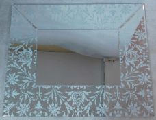 A contemporary wall mirror in a broad glazed and bevelled floral decorated frame. 120x100cm