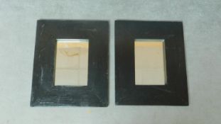 A pair of Eastern hardwood wall mirrors in broad ebonised frames. 60x50cm