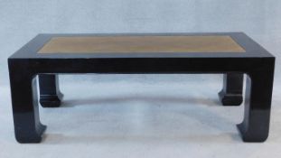 A Chinese style black lacquered low coffee table with inset woven rattan top. H.46 W.130 D.70cm