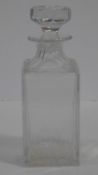 A Cartier French cut square crystal decanter with star cut design stopper. Signed to the base. H.