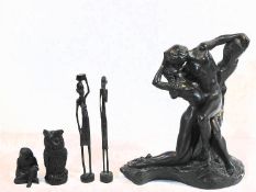 A figure of an owl carved from coal, two carved African standing figures and a resin figure group of