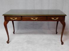 A 19th century style teak writing table with three frieze drawers on cabriole supports. H.76 W.140