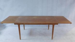 A vintage Danish style teak dining table with extending swivel action leaves. H.74 W.160 D.88cm