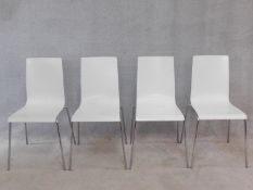 A set of four white moulded Galvano Tecnica stacking chairs on chrome tubular bases. H.86cm