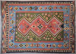A Qashqai Kilim with central repeating medallion on multi coloured ground within stylised flowerhead