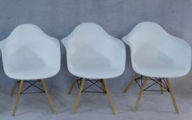 Three Eames style moulded tub armchairs. H.80cm