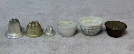 A collection of jelly moulds, Victorian and later, ceramic and metal. H.14cm (tallest)