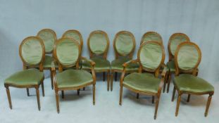 A set of ten Louis XVI style beech framed dining chairs in sage green velour upholstery, including