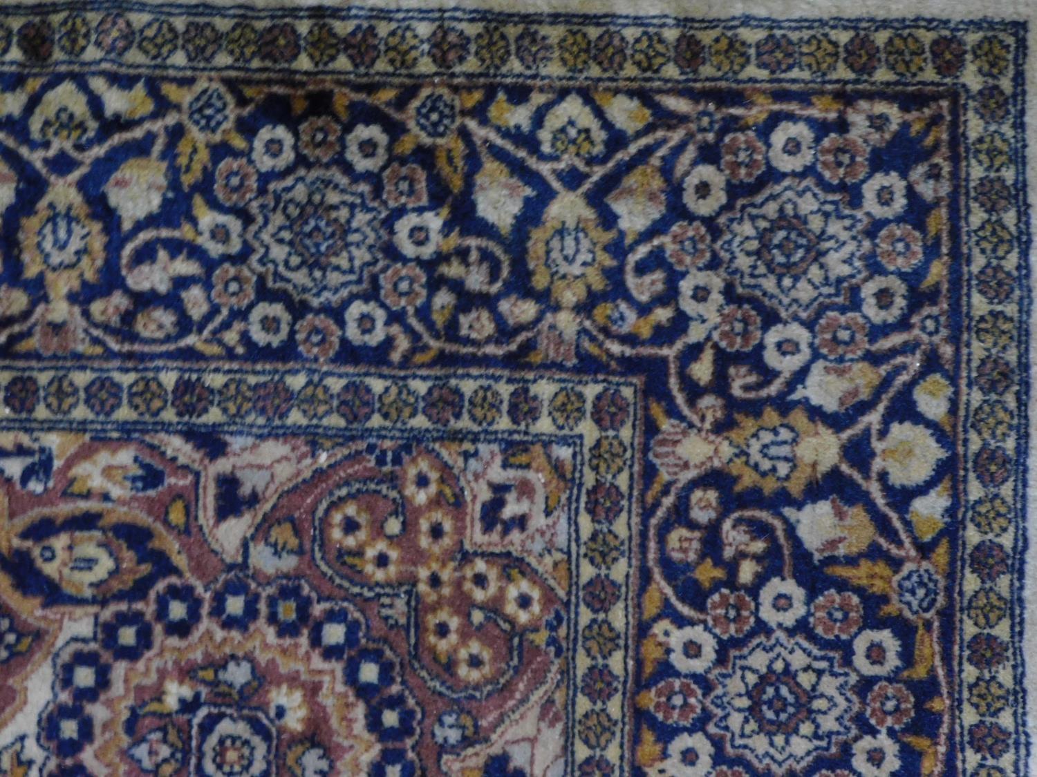 A Persian style rug with floral central medallion and allover scrolling foliate decoration on a - Image 2 of 3