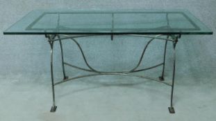 A wrought iron conservatory table with plate glass top. H.77 W.160 D.80cm