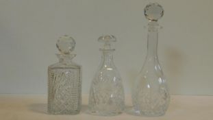 Three antique cut glass decanters with faceted stoppers. H.34cm