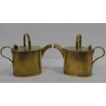 A pair of small brass 19th century conservatory watering cans with maker's stamp to the base. H.22