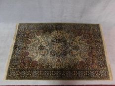 A Persian style rug with floral central medallion and allover scrolling foliate decoration on a