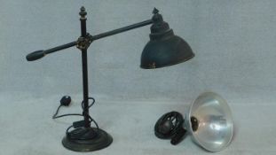 Two vintage industrial lights. One black enamel table lamp with adjustable arm and metal shade and a