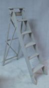 A vintage distressed grey painted step ladder with five steps and a platform top rung, labelled
