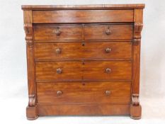 A Victorian mahogany chest of drawers with secret frieze drawer above two short over three long