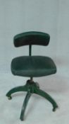 A vintage revolving office desk chair on cast iron base with casters. H.83cm