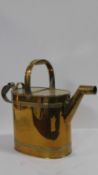 A 19th century brass watering can with makers trade mark to the base. H.43 W.53 D.21cm