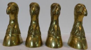 Two pairs of brass bookends in the form of eagle heads. H.17cm