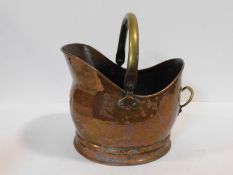 A vintage copper helmet shaped coal bucket with brass swing handle. 35x38cm