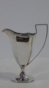 A Victorian silver geometric design silver cream jug on octagonal base with linear detailing to